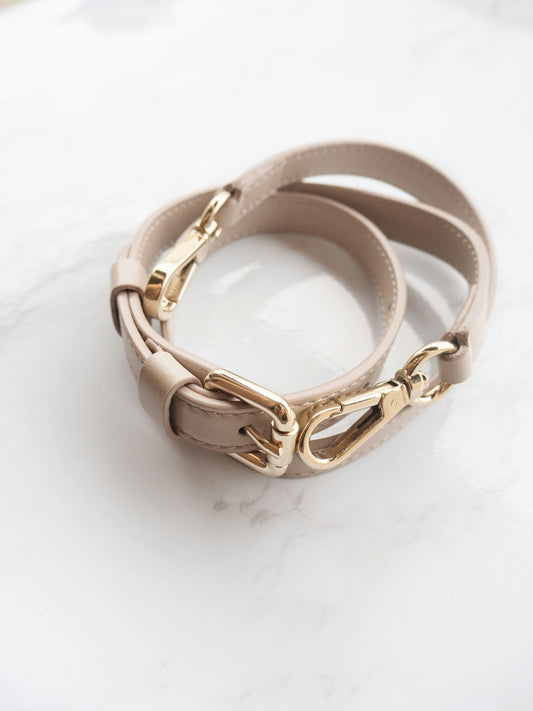 gold and silver bracelet on white surface