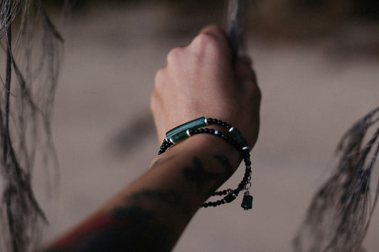 a person's arm with a bracelet on it