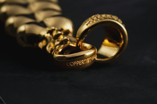 a couple of gold rings sitting on top of a table