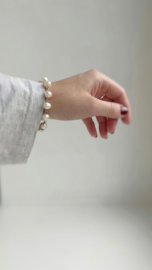 A woman's hand with a pearl bracelet