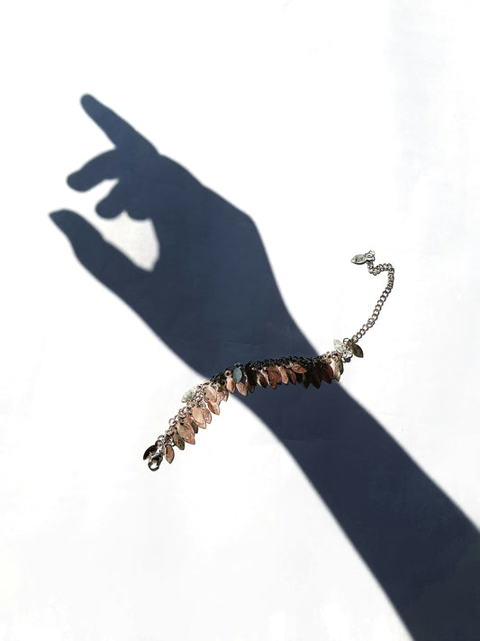 A person's shadow with a bracelet on it