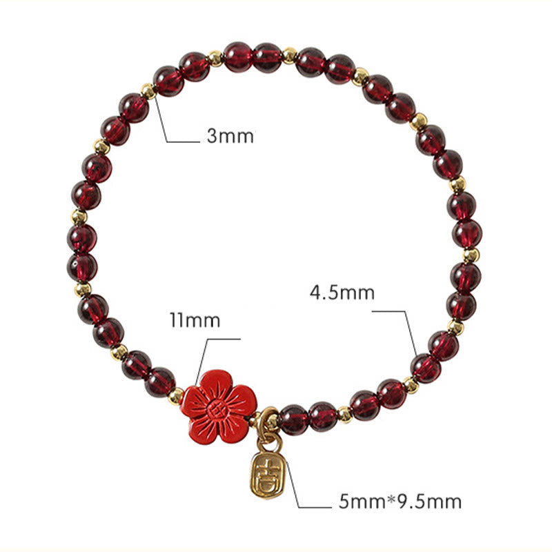 Pulsera Buddha Stones de oro de 14 quilates con flor de cinabrio y granate natural.
