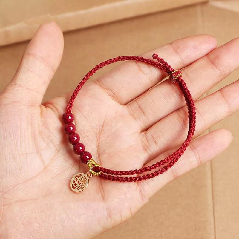 Pulsera trenzada hecha a mano con cuentas de cinabrio y carácter Fu de Buda con hilo rojo bendecido