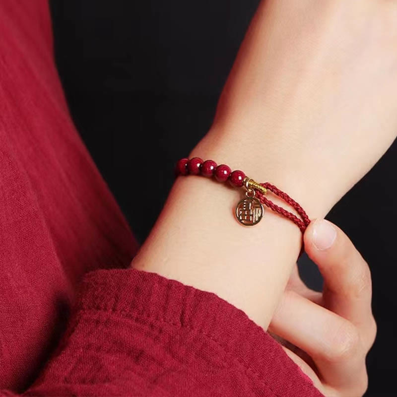 Pulsera trenzada hecha a mano con cuentas de cinabrio y carácter Fu de Buda con hilo rojo bendecido