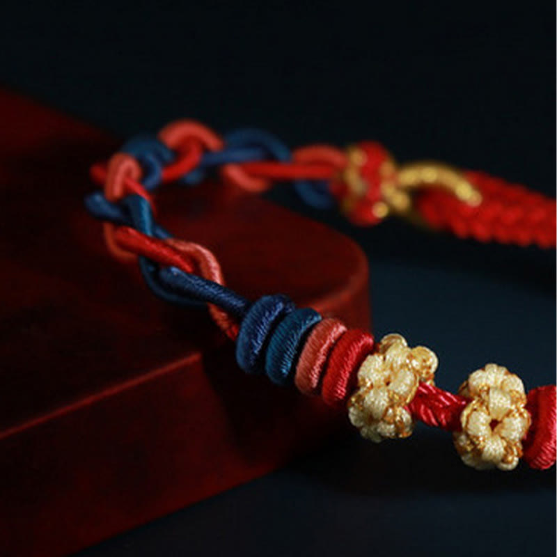 Pulsera de cuatro hilos con piedras de Buda y flor de durazno