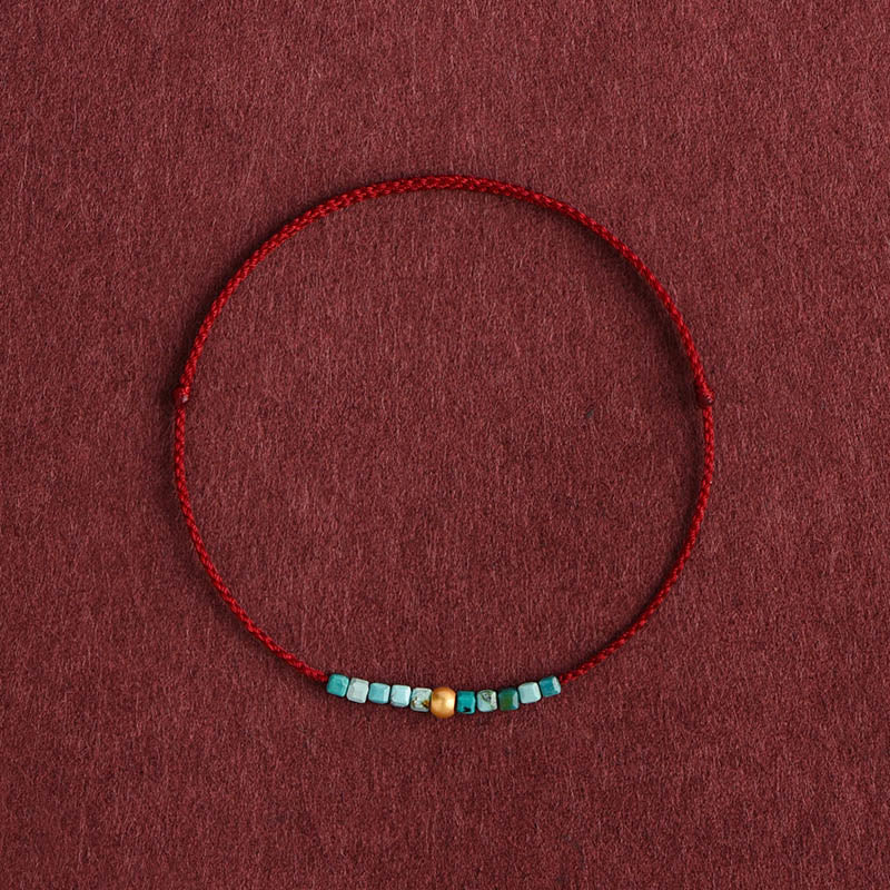 Pulsera trenzada con cuentas de oro 999 y turquesa para protección del tobillo.