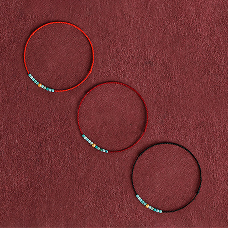 Pulsera trenzada con cuentas de oro 999 y turquesa para protección del tobillo.