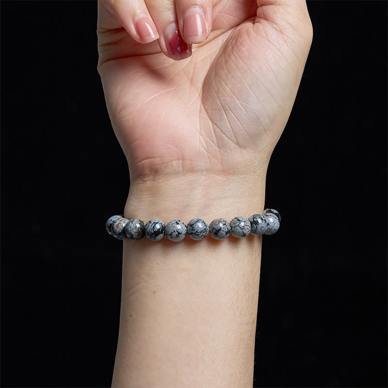 Pulsera de equilibrio de obsidiana y copo de nieve de piedra de Buda