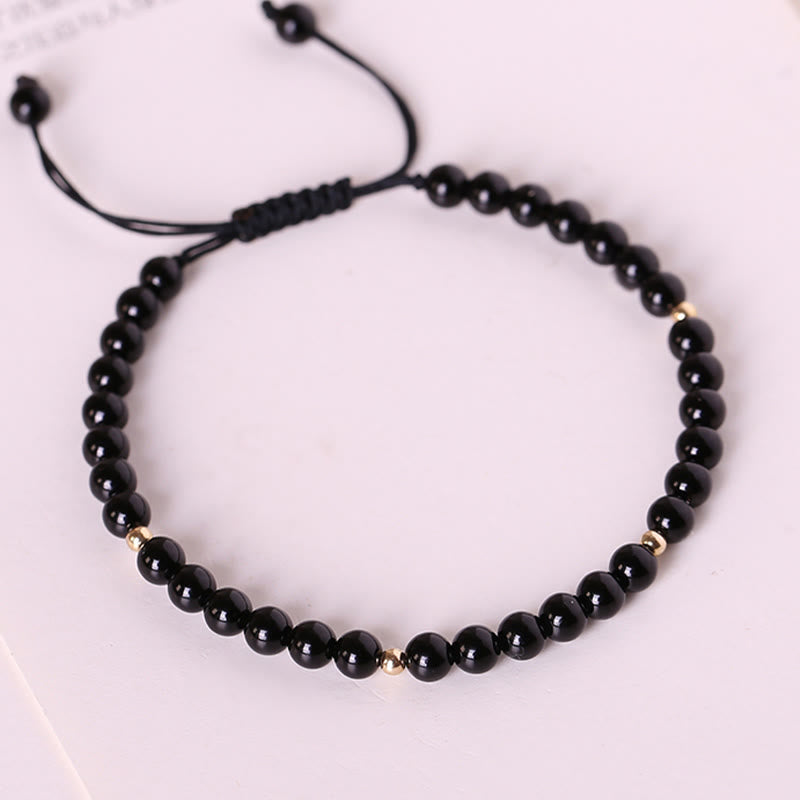 Pulsera de cuerda con pequeñas cuentas de obsidiana negra y piedras de Buda