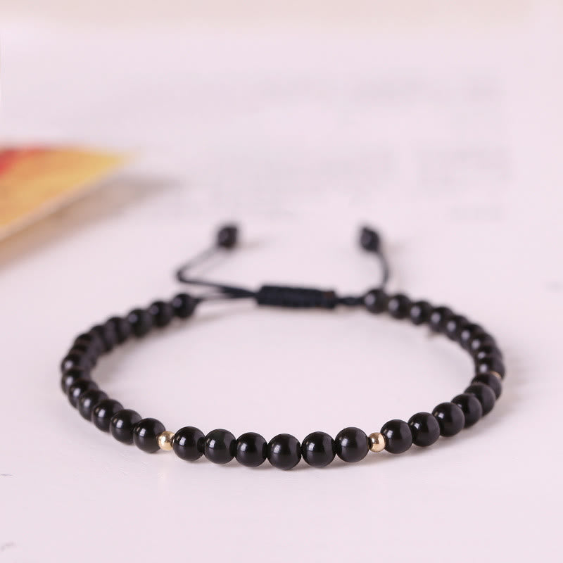 Pulsera de cuerda con pequeñas cuentas de obsidiana negra y piedras de Buda
