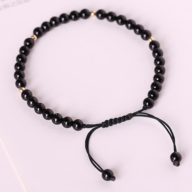 Pulsera de cuerda con pequeñas cuentas de obsidiana negra y piedras de Buda