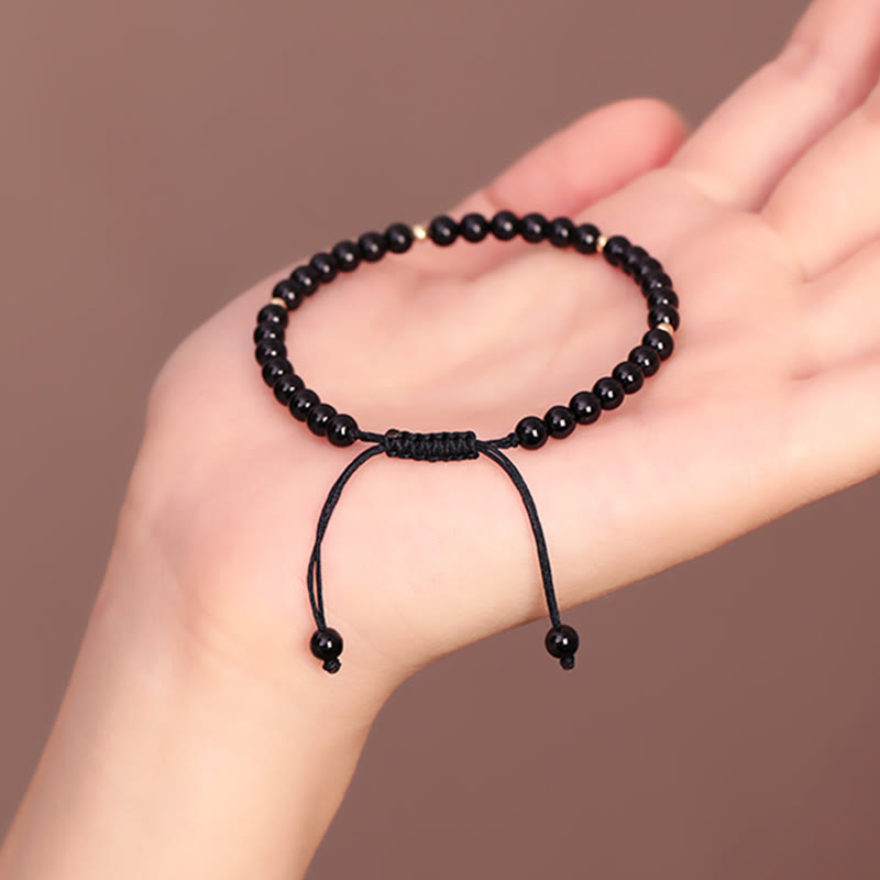 Pulsera de cuerda con pequeñas cuentas de obsidiana negra y piedras de Buda