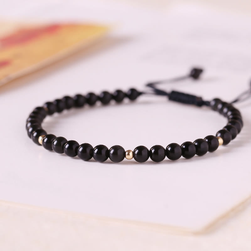Pulsera de cuerda con pequeñas cuentas de obsidiana negra y piedras de Buda