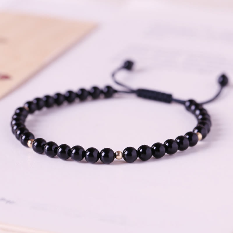Pulsera de cuerda con pequeñas cuentas de obsidiana negra y piedras de Buda
