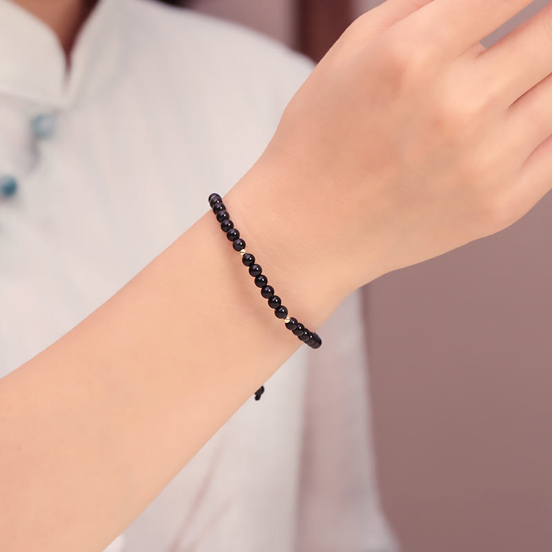 Pulsera de cuerda con pequeñas cuentas de obsidiana negra y piedras de Buda