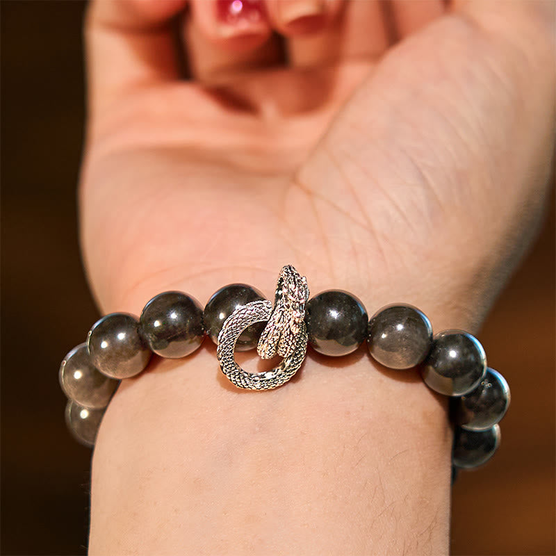 Pulsera protectora de obsidiana con dragón y piedras de Buda con brillo plateado