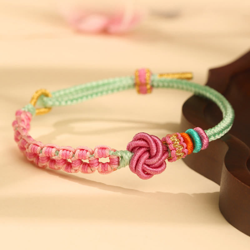 Pulsera trenzada con nudo de flor de durazno rosa y verde hecha a mano con piedras de Buda