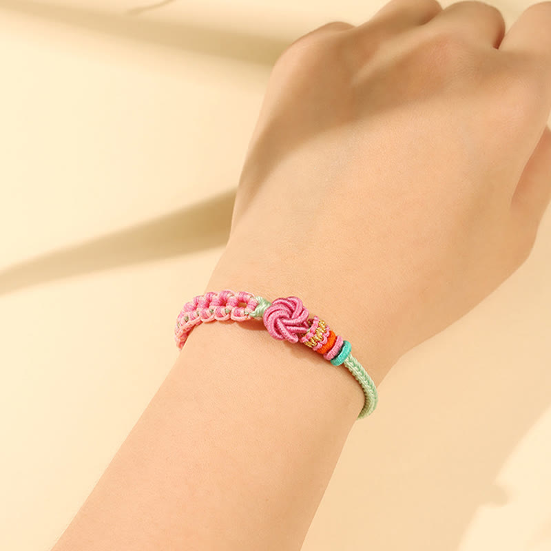 Pulsera trenzada con nudo de flor de durazno rosa y verde hecha a mano con piedras de Buda