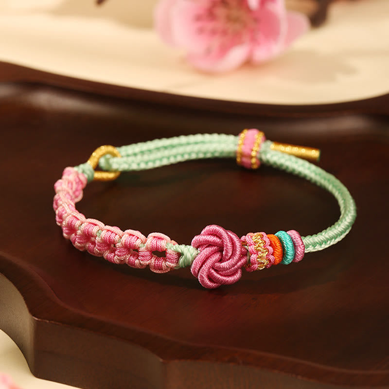 Pulsera trenzada con nudo de flor de durazno rosa y verde hecha a mano con piedras de Buda