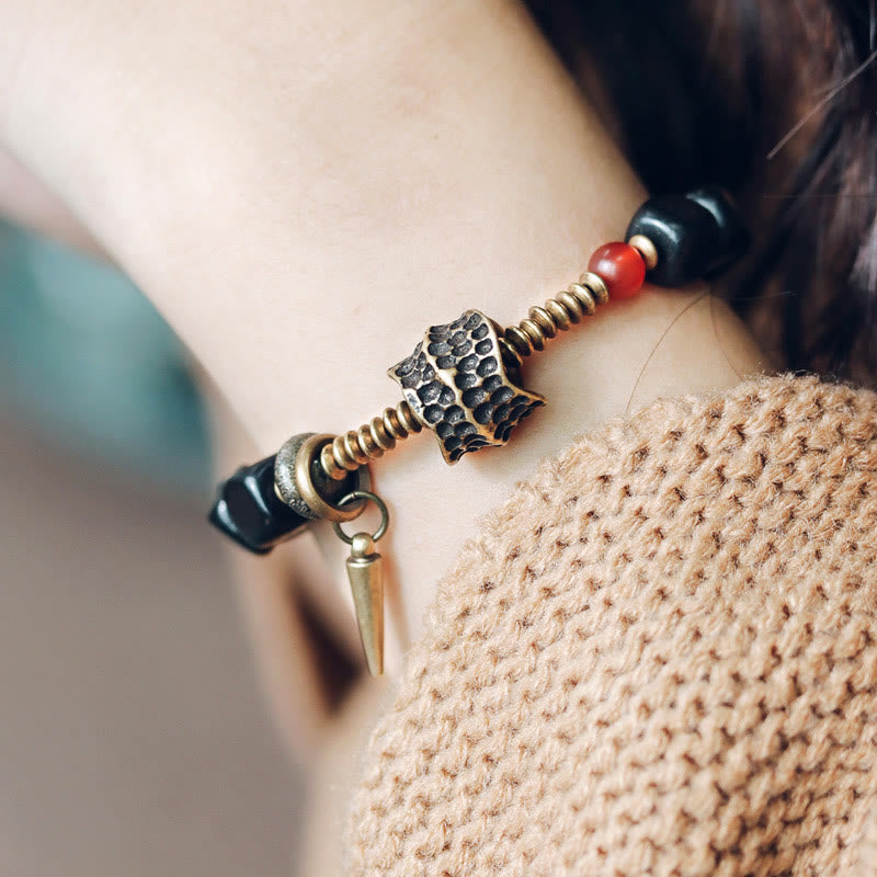 Pulsera de la paz con piedras de Buda, madera de ébano, cobre, latón y ágata roja