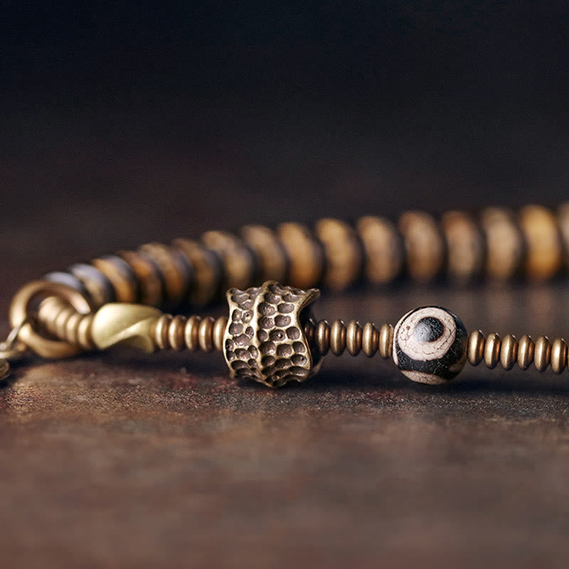 Pulsera de doble vuelta con piedras de Buda, hueso de yak, madera de ébano, cobre y latón.