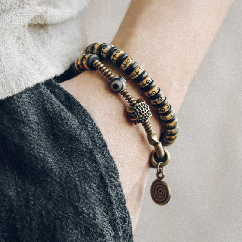 Pulsera de doble vuelta con piedras de Buda, hueso de yak, madera de ébano, cobre y latón.
