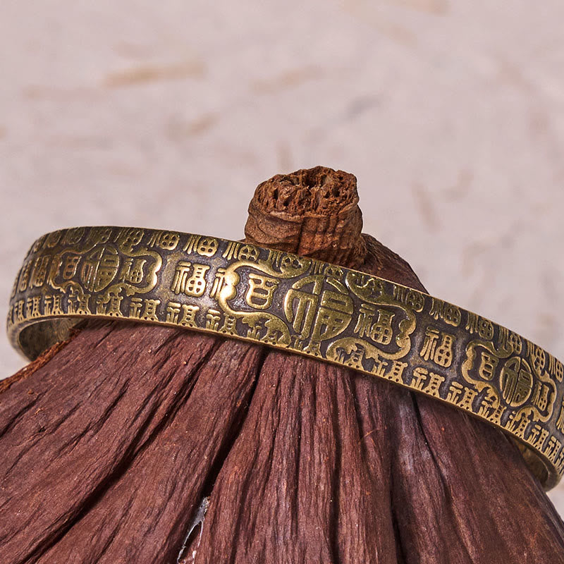 Pulsera de la suerte de cobre y latón con el símbolo Fu de las Cien Bendiciones de Buda