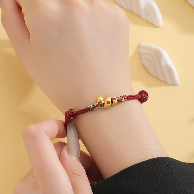 Pulsera trenzada de aleación de cobre con hilo rojo y piedras de Buda para proteger el Año de la Serpiente