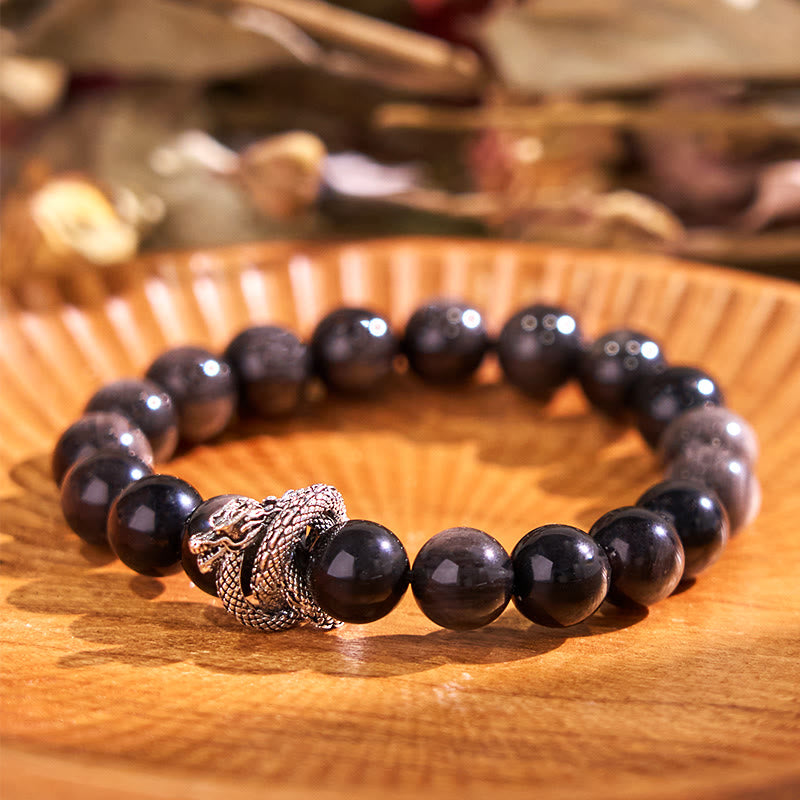 Pulsera protectora de obsidiana con dragón y piedras de Buda con brillo plateado
