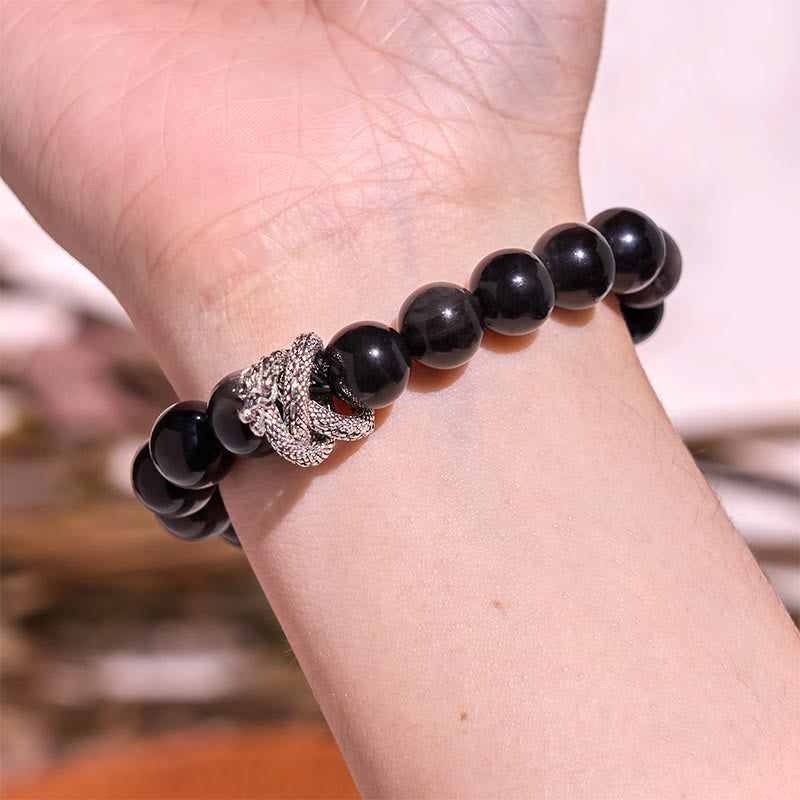 Pulsera protectora de obsidiana con dragón y piedras de Buda con brillo plateado