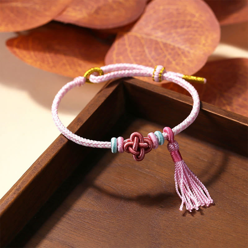 Pulsera protectora con borlas y nudo de flor de durazno con piedras de Buda