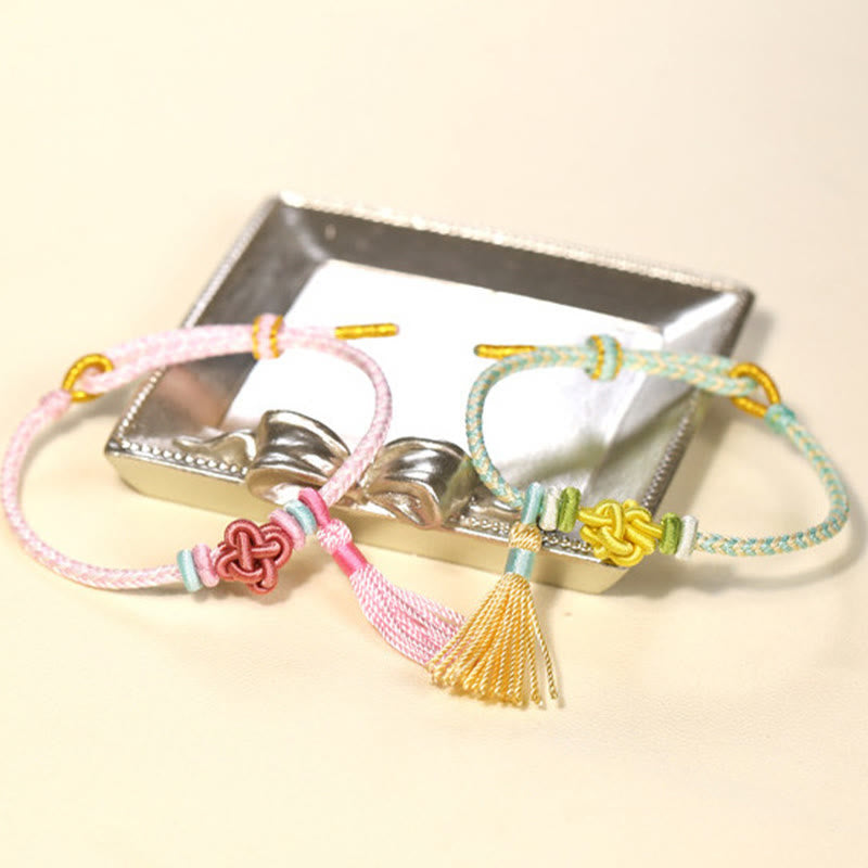 Pulsera protectora con borlas y nudo de flor de durazno con piedras de Buda