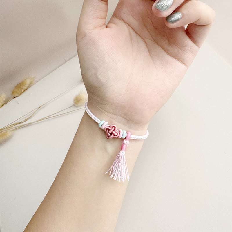 Pulsera protectora con borlas y nudo de flor de durazno con piedras de Buda