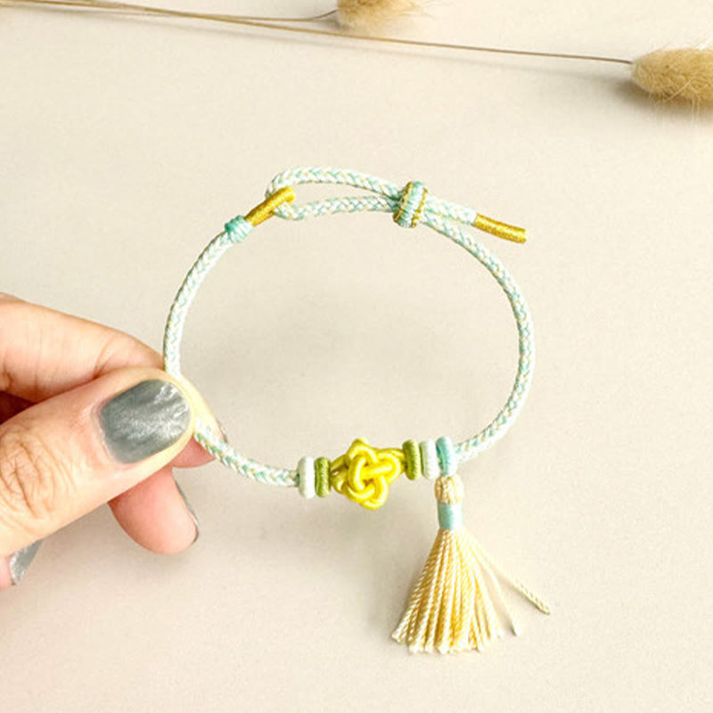 Pulsera protectora con borlas y nudo de flor de durazno con piedras de Buda