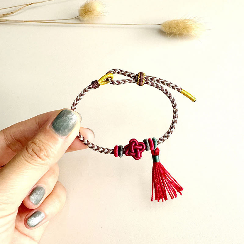 Pulsera protectora con borlas y nudo de flor de durazno con piedras de Buda