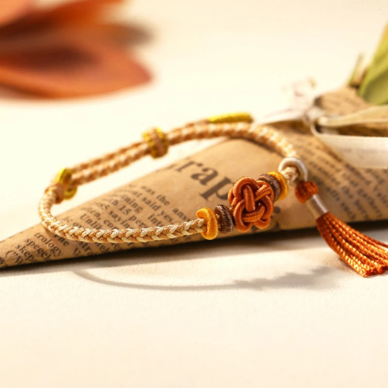 Pulsera protectora con borlas y nudo de flor de durazno con piedras de Buda