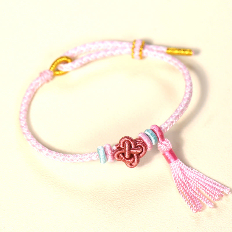 Pulsera protectora con borlas y nudo de flor de durazno con piedras de Buda