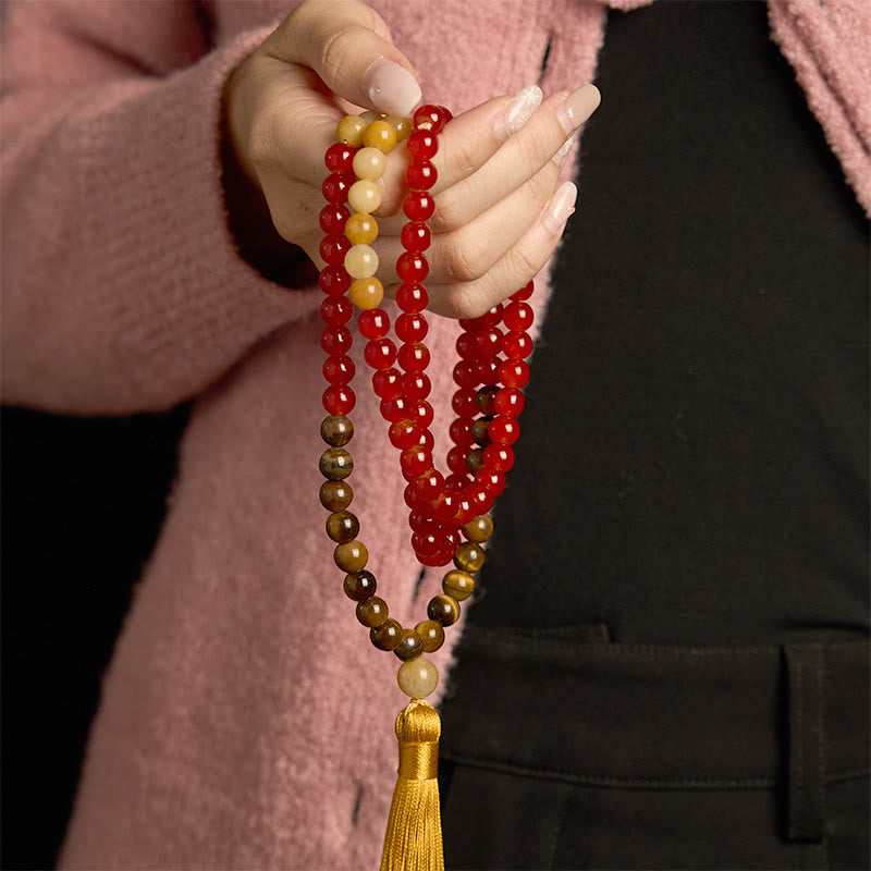 Pulsera de piedra de Buda con 108 cuentas de mala, ágata roja, ojo de tigre y borla amarilla.