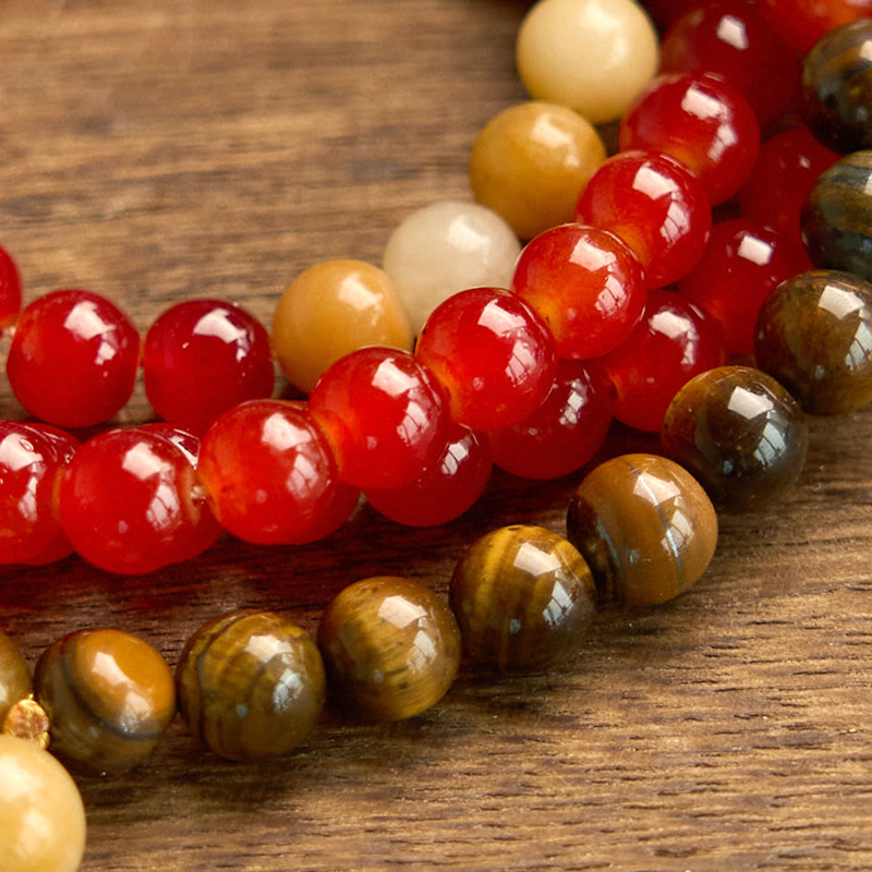 Pulsera de piedra de Buda con 108 cuentas de mala, ágata roja, ojo de tigre y borla amarilla.