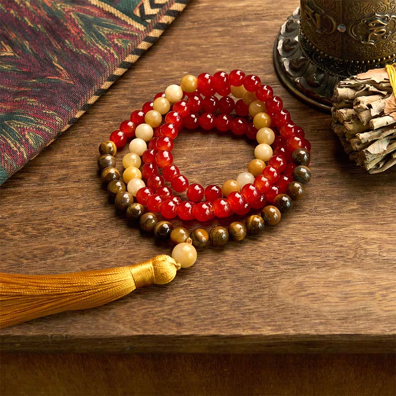 Pulsera de piedra de Buda con 108 cuentas de mala, ágata roja, ojo de tigre y borla amarilla.