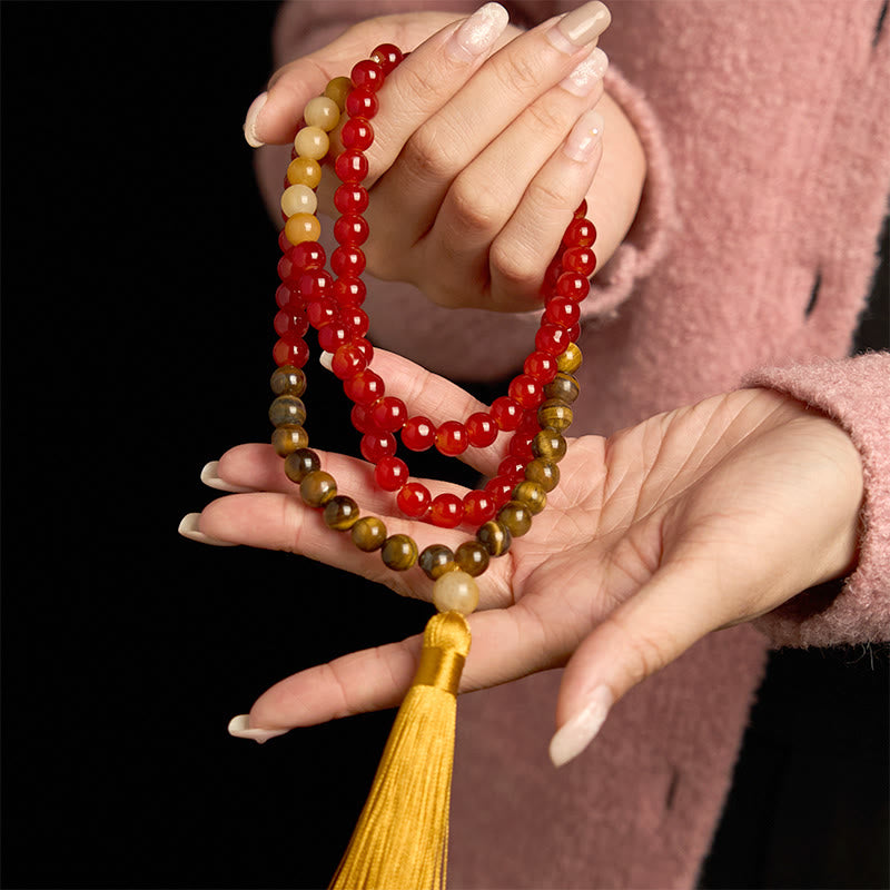 Pulsera de piedra de Buda con 108 cuentas de mala, ágata roja, ojo de tigre y borla amarilla.