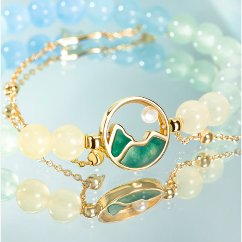 Conjunto de collar y pulsera con colgante de la suerte, piedras de Buda, cobre bañado en oro de 18 quilates, jade natural y calcedonia. Un panorama de ríos y montañas.