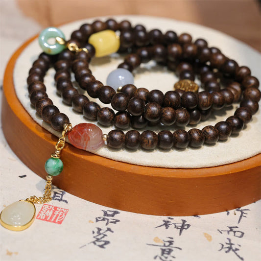 Pulsera de la paz con 108 cuentas de mala de Buda, madera de agar de Brunei, ámbar, ágata roja y jade con hebilla de la paz.
