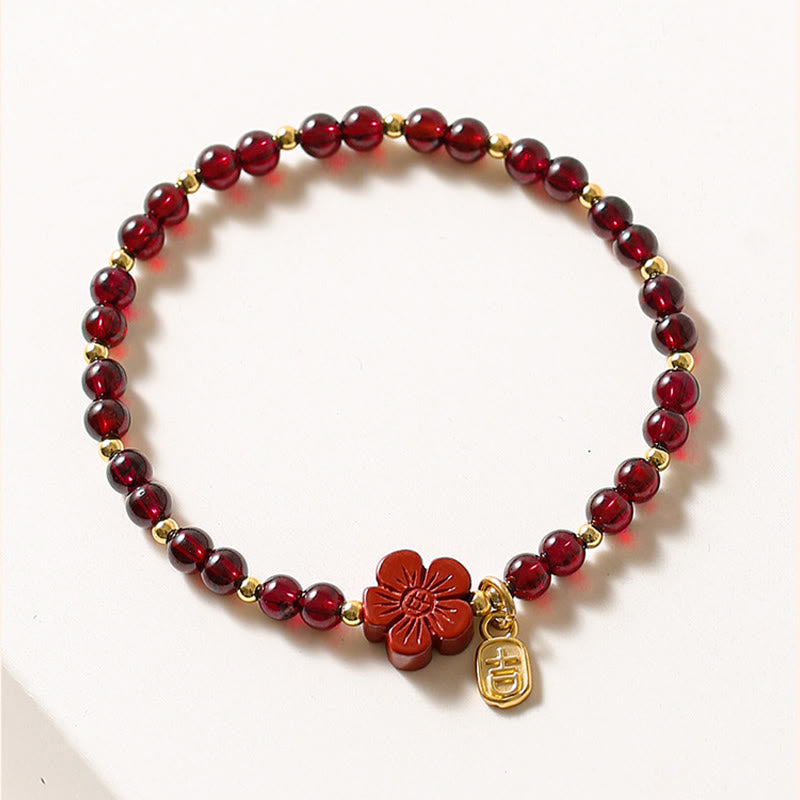 Pulsera Buddha Stones de oro de 14 quilates con flor de cinabrio y granate natural.