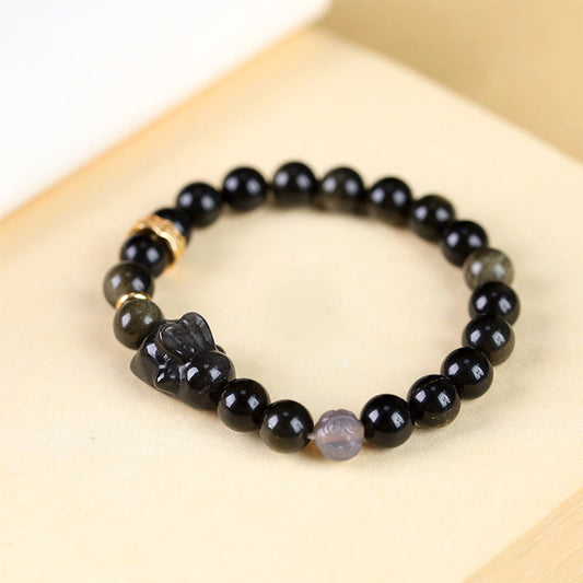 Pulsera protectora de conejo con piedras de Buda, obsidiana dorada, obsidiana negra y obsidiana plateada.