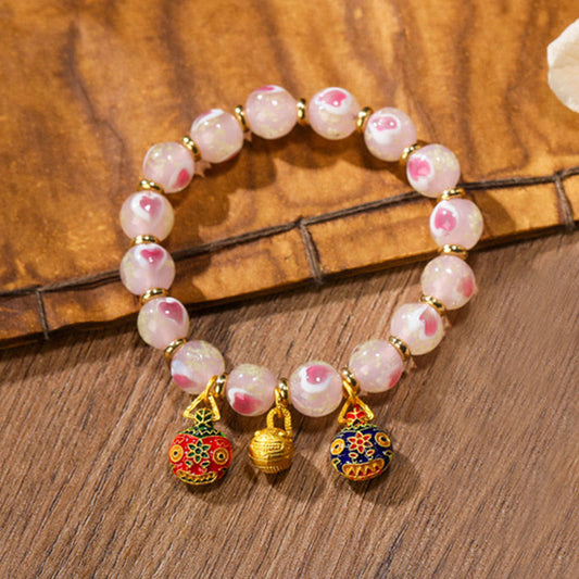 Pulsera con abalorios de cristal fluorescente Liuli con forma de corazón de amor rosa luminoso y piedras de Buda doradas.
