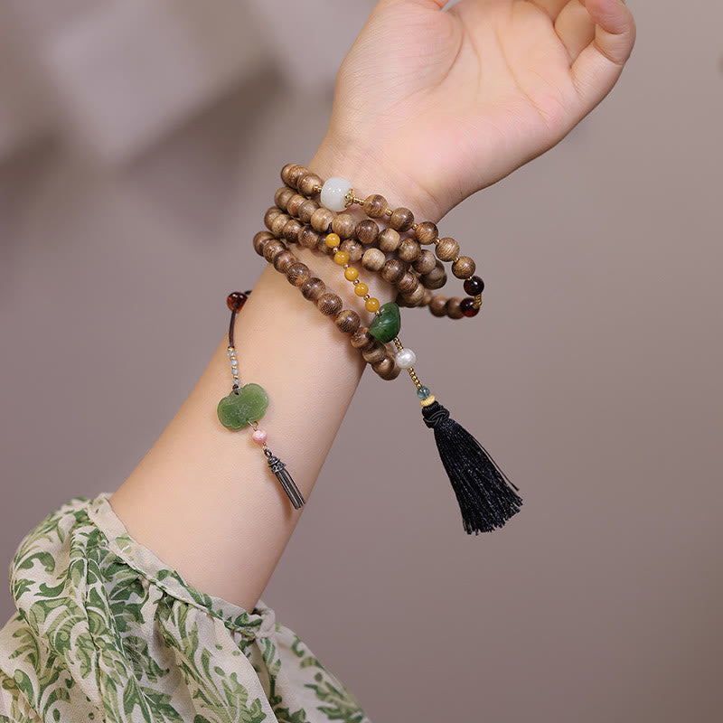 Pulsera con dijes de Ruyi, borlas, lingotes de jade, ámbar y madera de agar natural con piedras de Buda