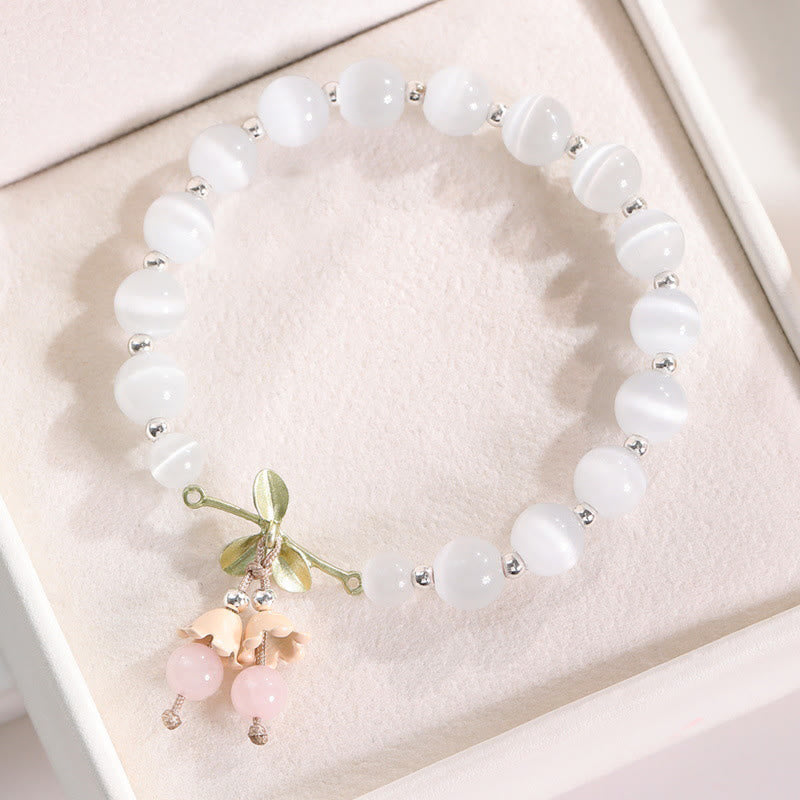 Pulsera con dijes de orquídea de la paz, calcedonia azul, aventurina verde y ojo de gato de Buda