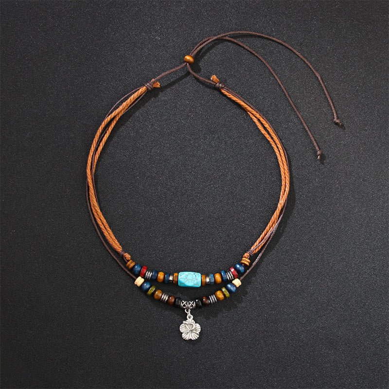 Pulsera con colgante de doble capa con protección de pequeñas flores turquesas y piedras de Buda