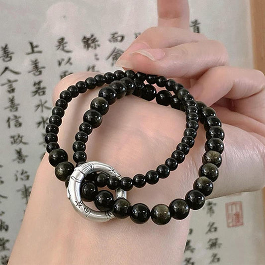 Pulsera de doble capa con obsidiana negra y piedras de Buda en plata de ley 999.